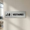 Signalétique vestiaires femme icône cintre sur fond alu brossé.